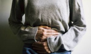 Woman suffering from stomach ache